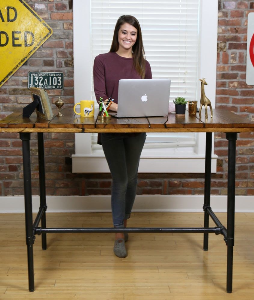 woman working at reclaimed-wood stand up desk