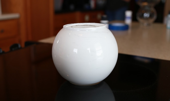 a round glass globe painted white on the inside
