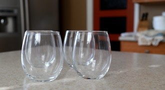 clear stemless wine glasses on counter