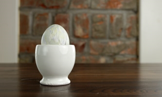 dyed egg in ceramic egg holder