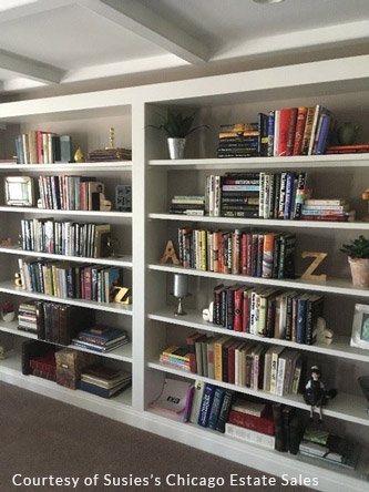 an organized bookshelf at an estate sale