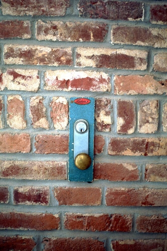 a door knob on a brick wall